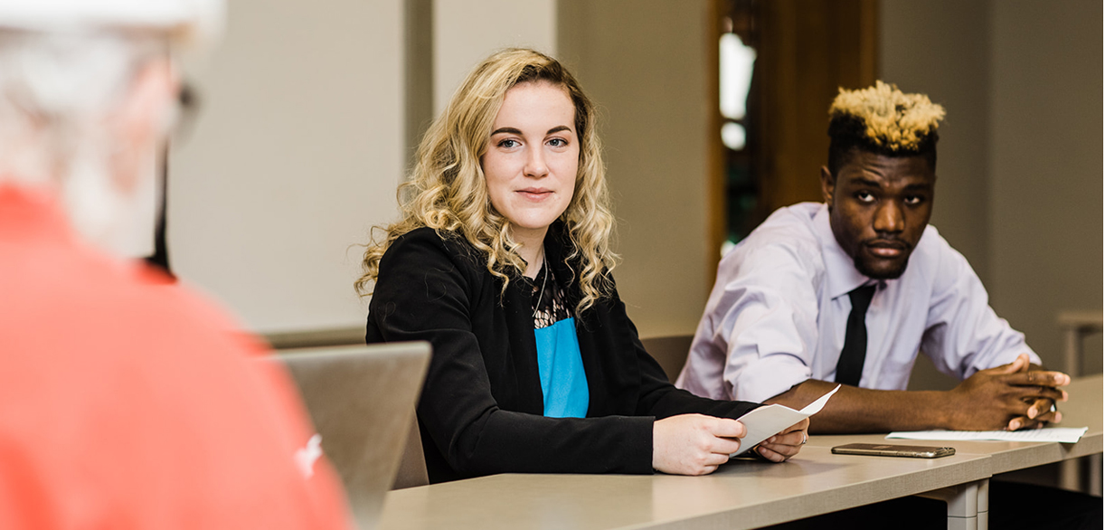 Female and male student in business class