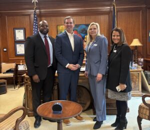 Dr. Kenworthy with Governor Andy Beshear, Spalding Board Chair Kellie Sheryak, and Spalding Trustee Thomas Williams.