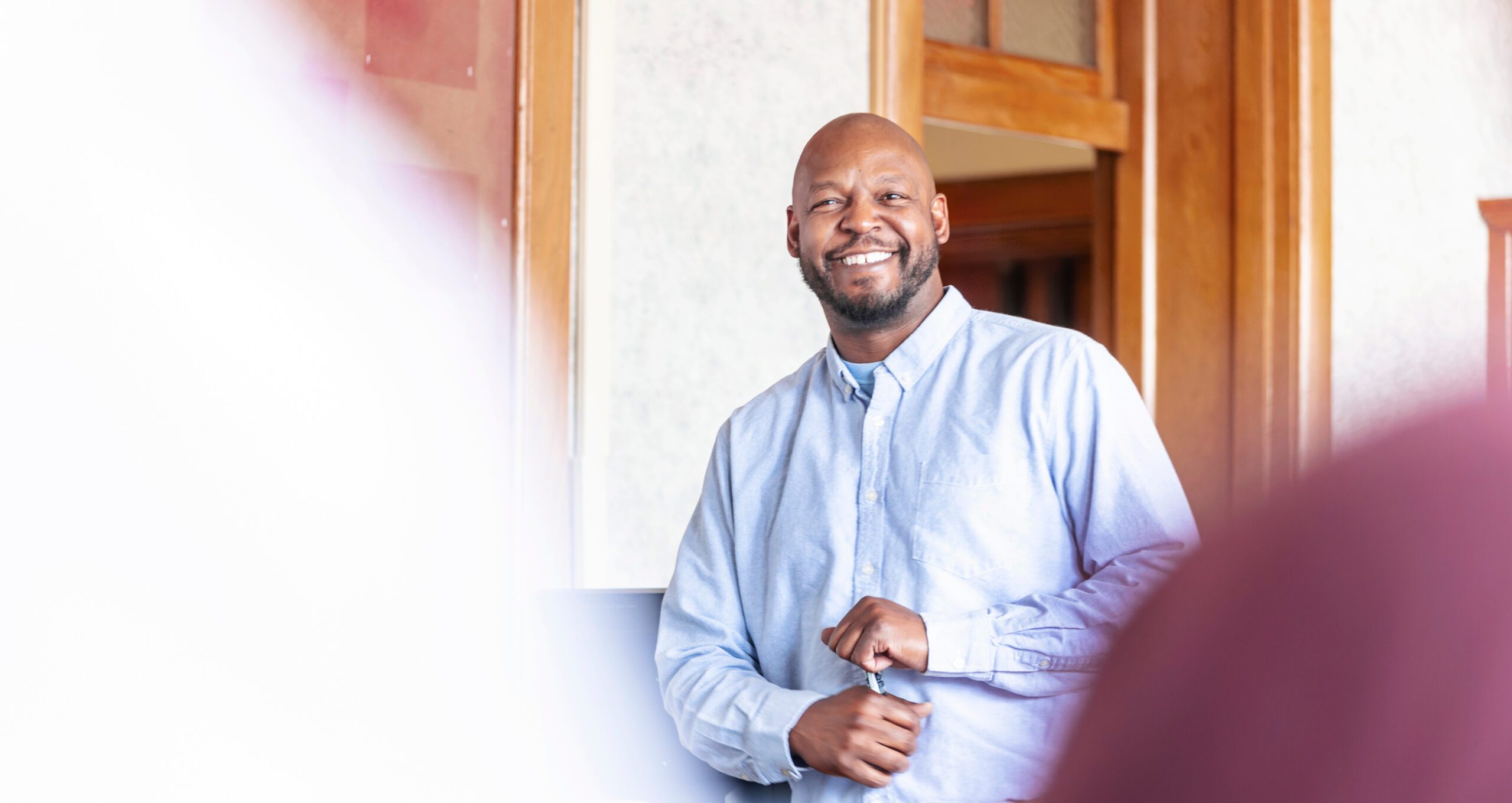 male professor smiling at class