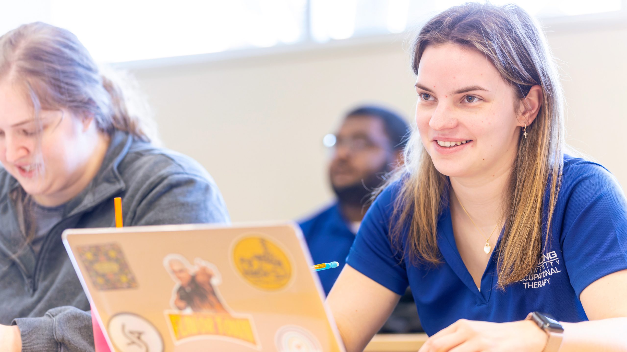 female student in class on laptop