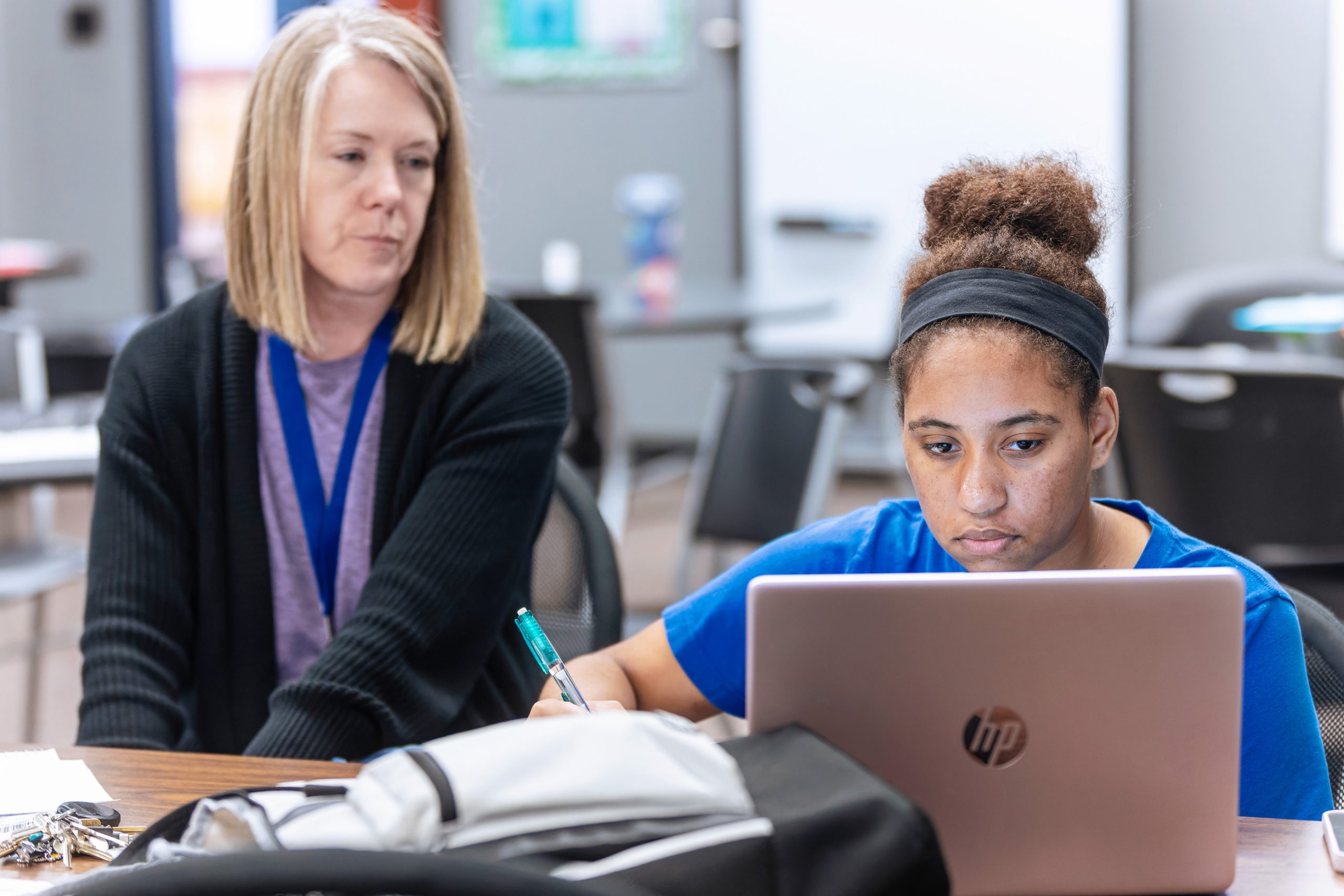 teacher and student with laptop