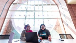 two female students on laptops