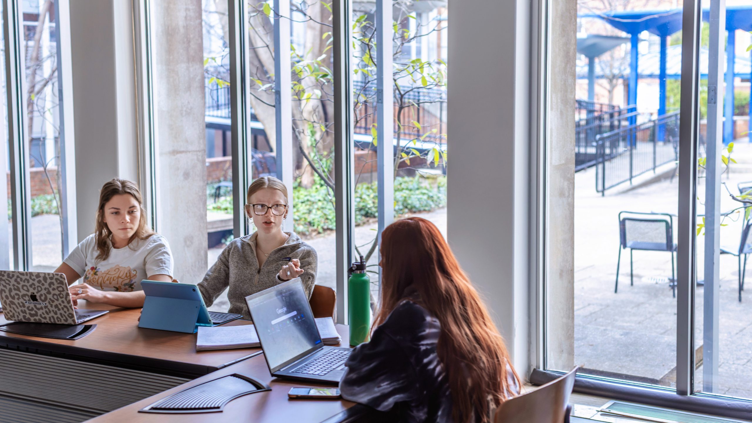 female students on laptops inside